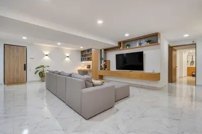 a living room with a couch and a flat screen tv at Opulent and Luxury 4 Bedroom in Sabaneta