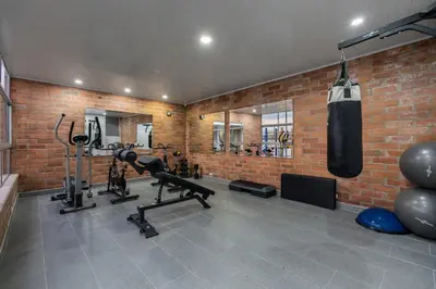 a gym with a punching bag hanging from a brick wall at Opulent and Luxury 4 Bedroom in Sabaneta