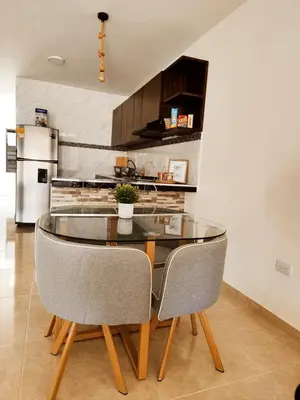 a dining room with a glass table and chairs at Casa del Sol in Mariquita