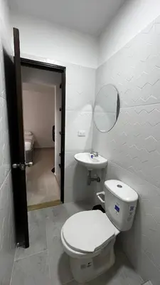 a bathroom with a toilet and a sink at Casa del Sol in Mariquita