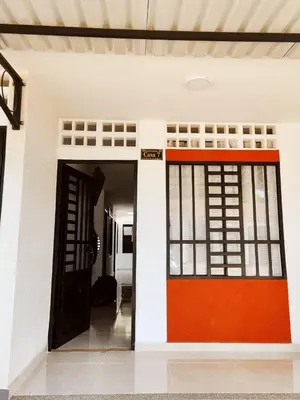 an open door of a house with a red door at Casa del Sol in Mariquita