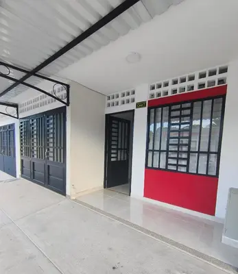 a building with two doors and a red wall at Casa del Sol in Mariquita