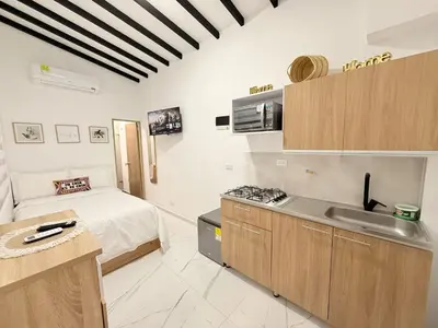 a kitchen with a bed and a sink in a room at Aparta estudio 204 - Casa Bendita in Medellín
