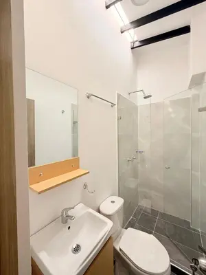 a bathroom with a sink and a toilet and a shower at Aparta estudio 204 - Casa Bendita in Medellín