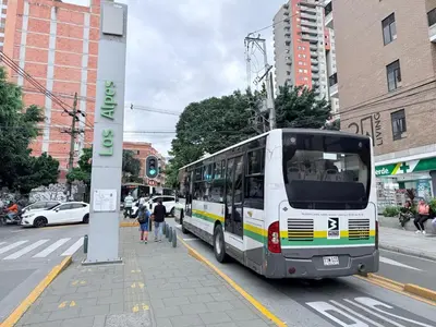 a bus parked on the side of a city street at Aparta estudio 204 - Casa Bendita in Medellín