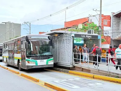 a bus with people waiting at a bus stop at Aparta estudio 204 - Casa Bendita in Medellín