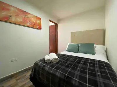 a bedroom with a bed with two slippers on it at Apartamento 2 habitaciones Viva Envigado in Envigado