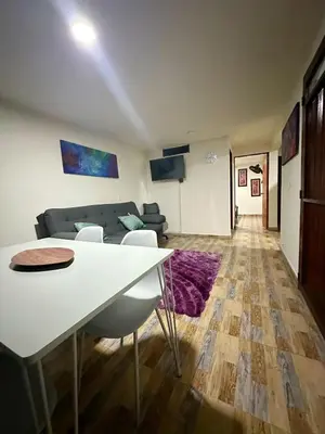 a living room with a table and a couch at Apartamento 2 habitaciones Viva Envigado in Envigado