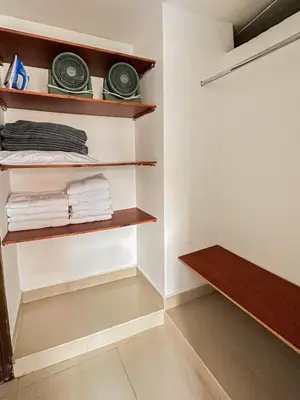a walk in closet with wooden shelves and towels at Excelente Ubicación en La 70-Laureles in Medellín