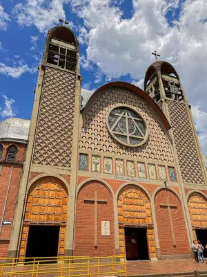 a large church with a cross and a clock tower at Excelente Ubicación en La 70-Laureles in Medellín