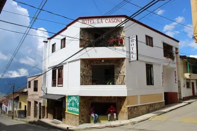 a white building on the corner of a street at Hotel La Casona Ituango in Ituango