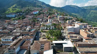 an aerial view of a city with mountains at Hotel La Casona Ituango in Ituango