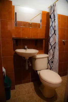 a bathroom with a toilet and a sink at Hotel La Casona Ituango in Ituango
