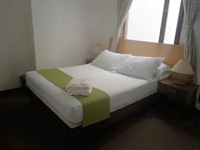 a bedroom with a bed with a towel on it at Hotel Confort LaCeja in La Ceja
