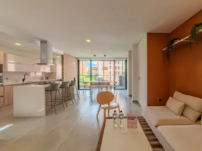 a living room and kitchen with a couch and a table at The Living House by Wynwood House in Medellín