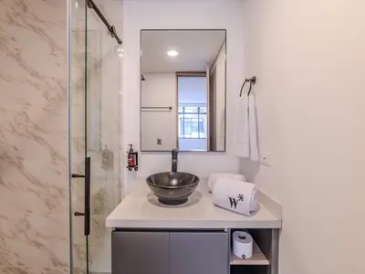 a bathroom with a sink and a mirror at The Living House by Wynwood House in Medellín