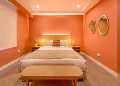 a bedroom with a large bed and two mirrors at Contemporary Space Steps from El Tesoro 305 in Medellín