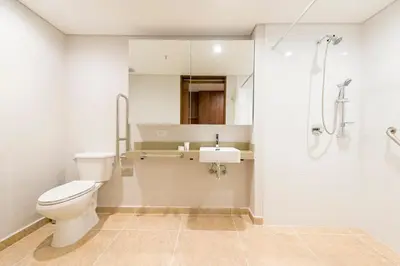 a bathroom with a toilet and a sink and a shower at El Tesoro Escape Modern & Cozy Room 303 in Medellín