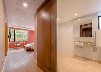 a bathroom with a wooden door and a sink at Comfort and Style -Exclusive Area in El Tesoro 307 in Medellín