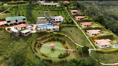 an aerial view of a house with a pond at Centro vacacional campo verde in Cocorná