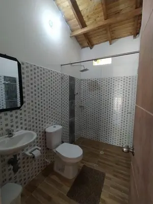 a bathroom with a toilet and a sink at Centro vacacional campo verde in Cocorná