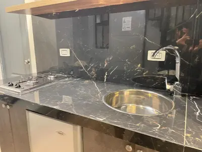 a black counter top with a sink in a kitchen at Apartamento pequeño la 70 estadio laurles in Medellín