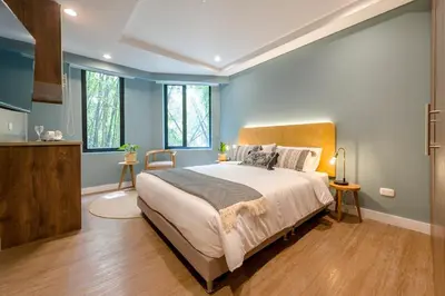 a bedroom with a large bed and some windows at Vibrant Space- Explore Wonders in El Tesoro 313 in Medellín