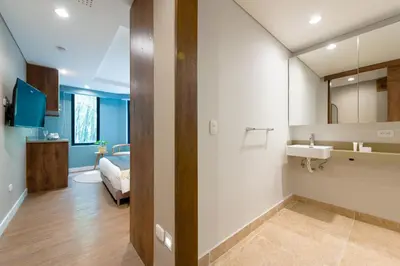 a bathroom with a sink and a mirror at Vibrant Space- Explore Wonders in El Tesoro 313 in Medellín