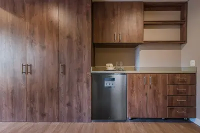 a kitchen with wooden cabinets and a dishwasher at Elegant Space in El Tesoro Recharge in Comfort 308 in Medellín
