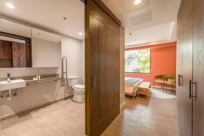 a bathroom with a sink and a toilet and a bedroom at Elegant Space in El Tesoro Recharge in Comfort 308 in Medellín