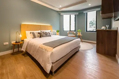 a bedroom with a large bed in a room at El Tesoro Stylish Escape - Urban Vibes 312 in Medellín