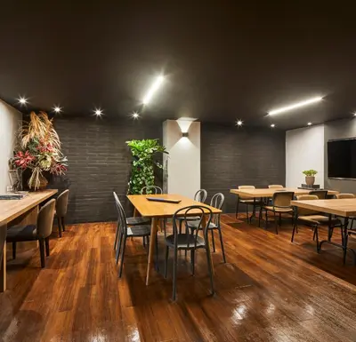 a dining room with wooden tables and chairs at El Tesoro Stylish Escape - Urban Vibes 312 in Medellín