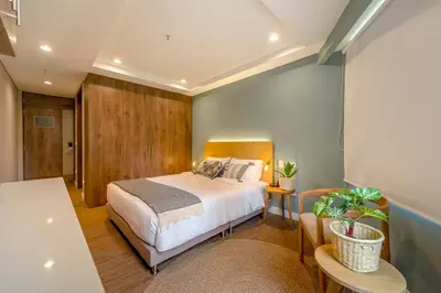 a bedroom with a bed and a table at El Tesoro Stylish Escape - Urban Vibes 312 in Medellín