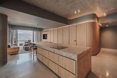 a large kitchen with a counter and a large window at The Somos Loho Hotel in Medellín