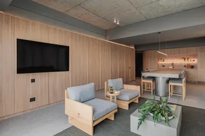 a living room with a television and a table and chairs at The Somos Loho Hotel in Medellín