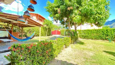 a yard with a hammock and a house at Espectacular finca , San Jerónimo in San Jerónimo