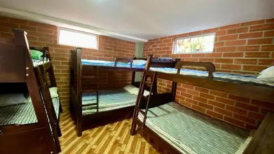 a room with three bunk beds in a brick wall at Espectacular finca , San Jerónimo in San Jerónimo