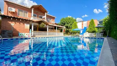 a swimming pool in front of a house at Espectacular finca , San Jerónimo in San Jerónimo
