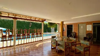 a porch with a table and chairs on a balcony at Espectacular finca , San Jerónimo in San Jerónimo