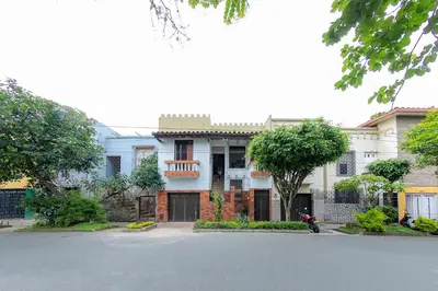 a house with a motorcycle parked in front of it at Ayenda Sarayu House in Medellín