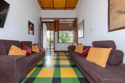 a living room with two couches and a colorful floor at Ayenda Sarayu House in Medellín