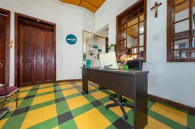 a lobby with a desk with a computer on it at Ayenda Sarayu House in Medellín