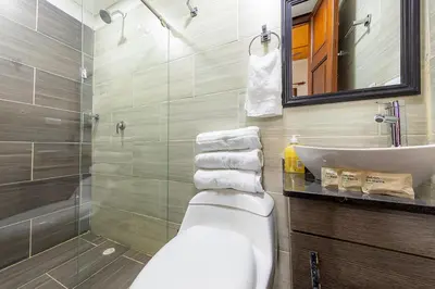 a bathroom with a toilet and a sink and a mirror at Ayenda Sarayu House in Medellín