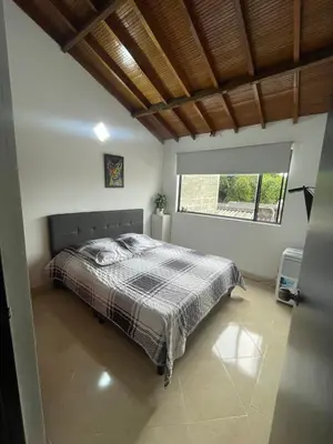 a bedroom with a bed and a large window at Hermosa Casa vía al nevado, termales del otoño, cerca al bosque complejo deportivo y clínica, sector san Marcel in Manizales