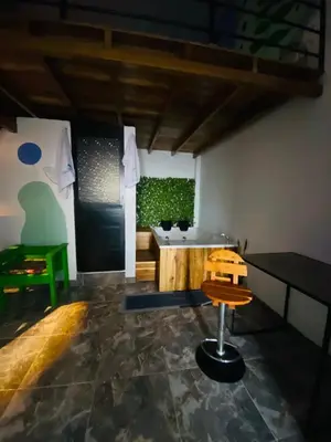 a bathroom with a sink and a chair in a room at Habitación tipo loft turistico in Mariquita