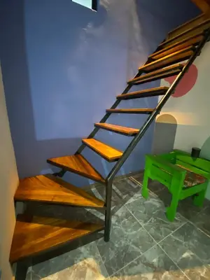 a set of wooden stairs in a room at Habitación tipo loft turistico in Mariquita