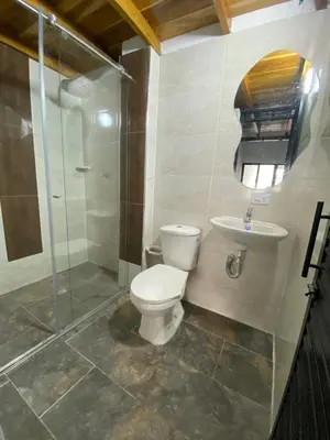 a bathroom with a toilet and a sink and a shower at Habitación tipo loft turistico in Mariquita