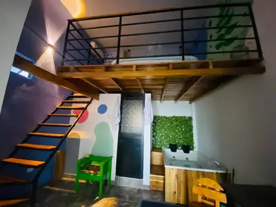 a room with a loft bed and a bathroom at Habitación tipo loft turistico in Mariquita
