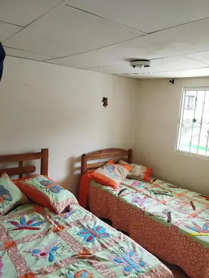 a bedroom with two beds and a window at Casa finca en pueblo rico Neira in Neira