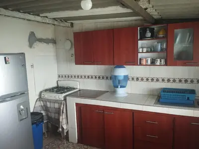 a kitchen with red cabinets and a blue blender at Casa finca en pueblo rico Neira in Neira